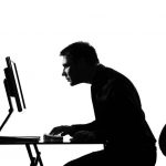 hunched over the computer